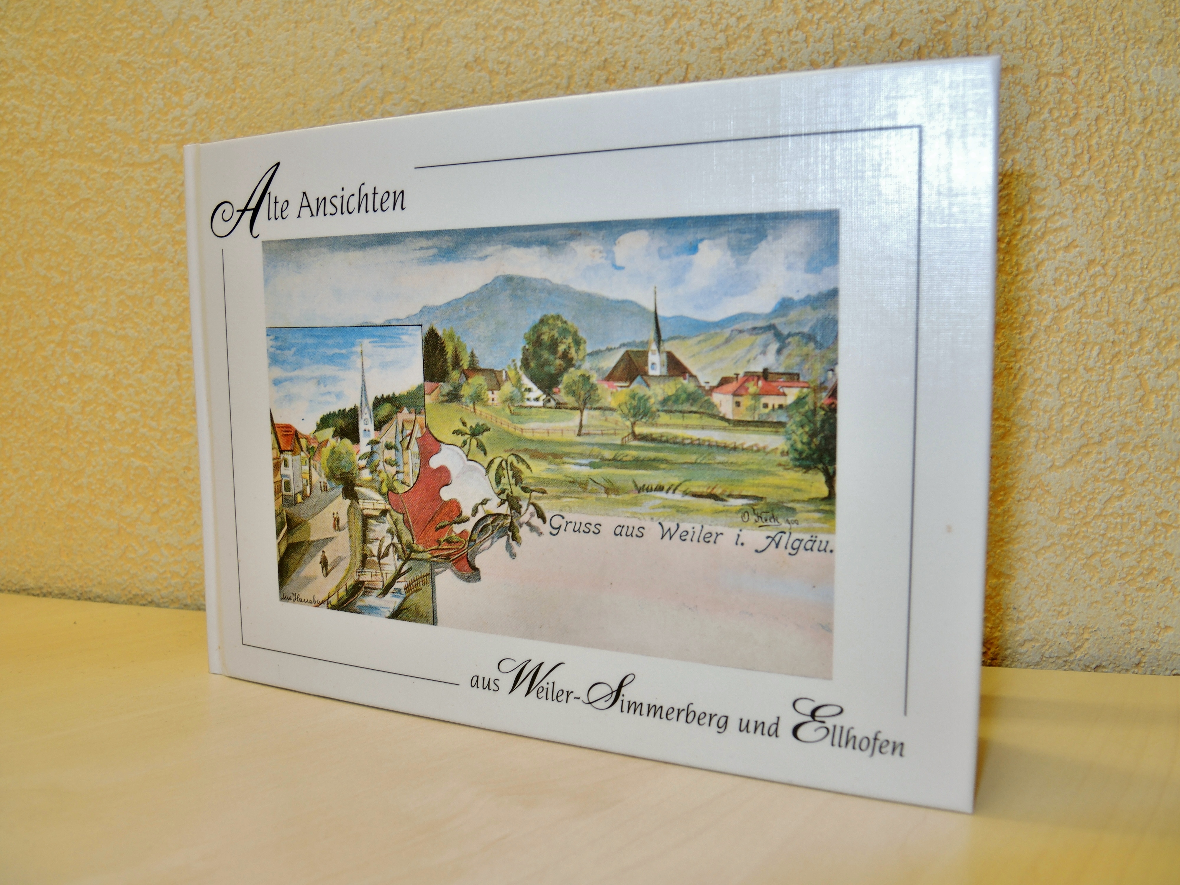  weißes Buch mit gemalten Bild von Ortschaft auf Vorderseite und Aufschrift "Alte Ansichten Weiler-Simmerberg-Ellhofen - das Bild wird mit Klick vergrößert 